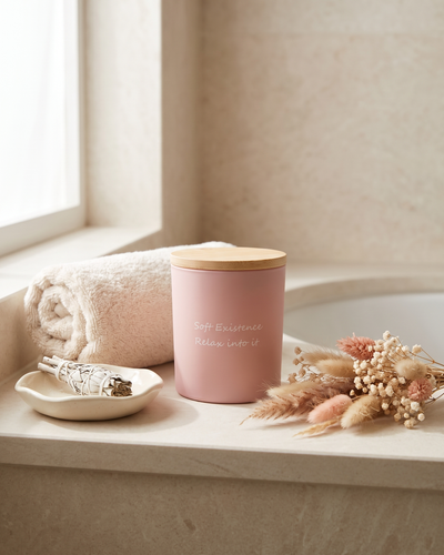 The Nocturne soy candle in its soft pink frosted vessel with a bamboo lid