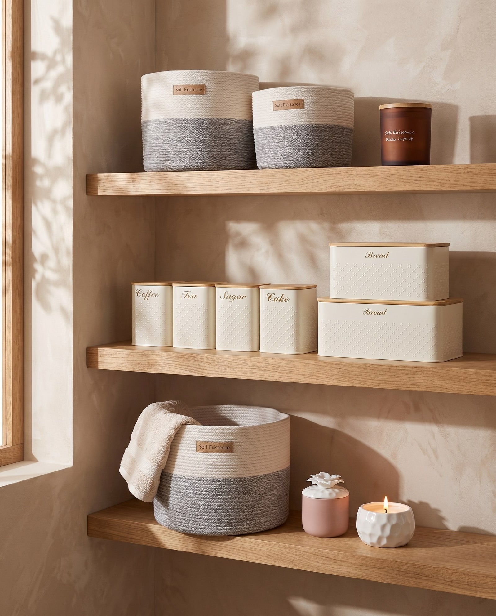 Oak shelving layered with woven cotton baskets, cream kitchen canisters and Soft Existence soy candles